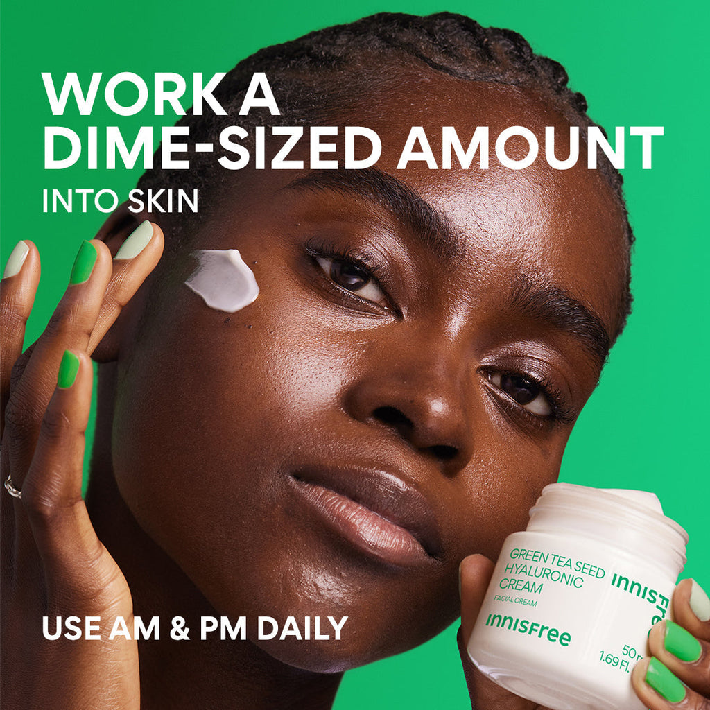 Person with a dab of cream on her cheek holding a jar of innisfree Green Tea Seed Hyaluronic Cream, suggesting AM & PM use